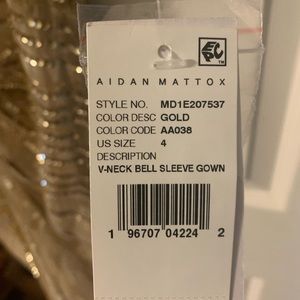 A long sleeved elegant gold dress perfect for any formal occasion.